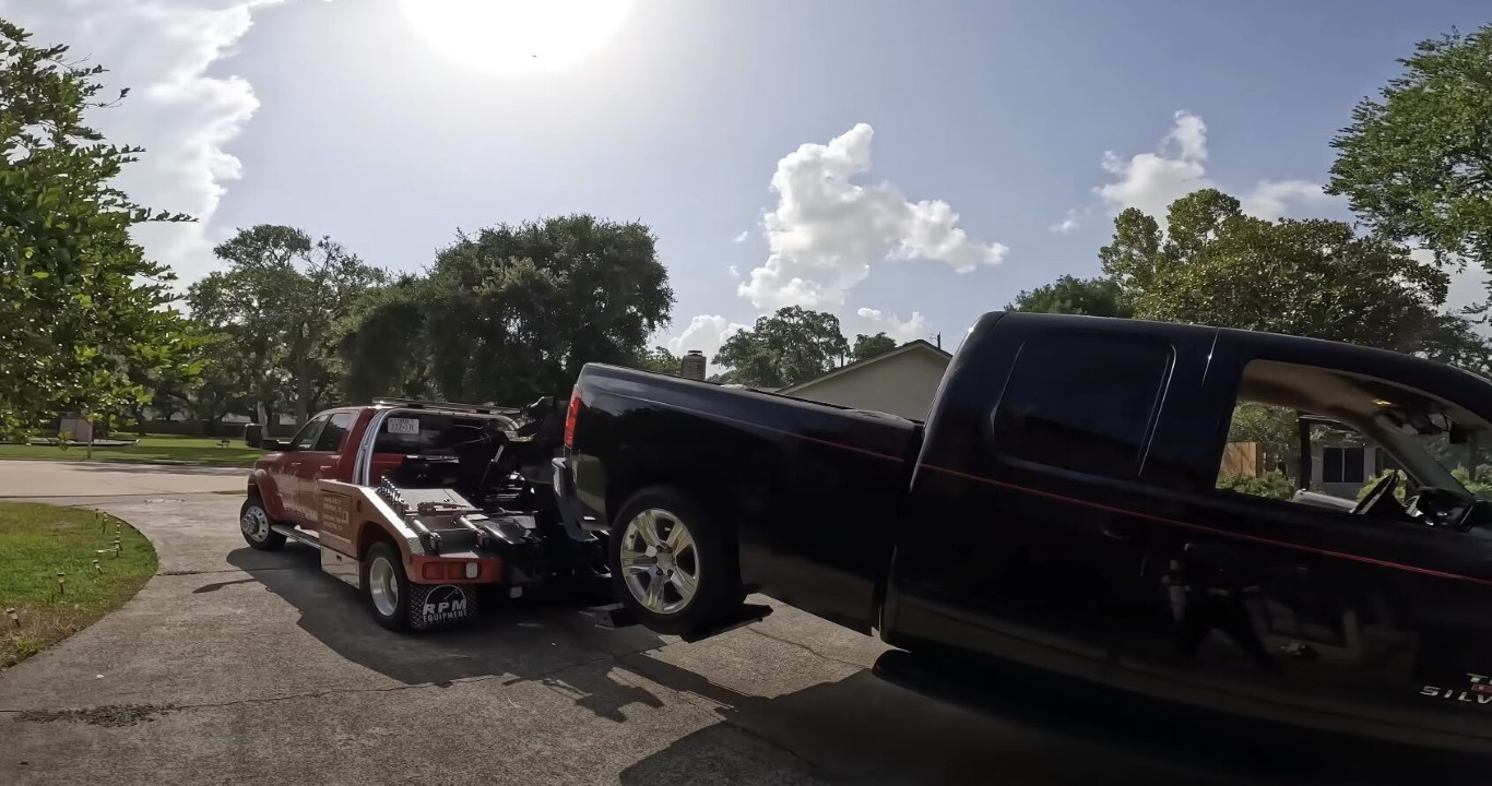 Accident recovery tow truck removing a vehicle from a residential street in West Islip, NY